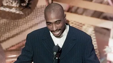 Tupac Shakur presents an award at the 38th Annual Grammy Awards at the Shrine Auditorium.