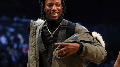 Feb 12, 2018; Brooklyn, NY, USA; American rapper Joey Bada$$ looks on from courtside during the fourth quarter between the
