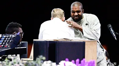 Kanye West hugs Pastor Adam Tyson at the annual Strength to Stand Youth Conference at the LeConte Center in Pigeon Forge, Tenn.