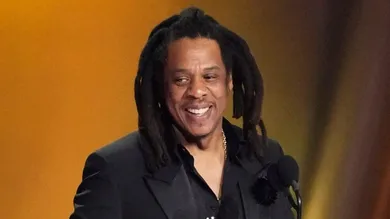Jay-Z , left, accepts the Dr. Dre Global Impact Award with his daughter Blue Ivy on stage.