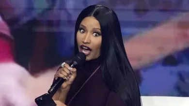Nicki Minaj takes the stage with Erika Kirk at the Phoenix Convention Center during the final day of AmericaFest on Dec. 21,