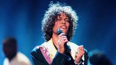 Whitney Houston rehearses with members of the choir "God's Property" at the Nashville Arena April 22, 1998 in preparation for