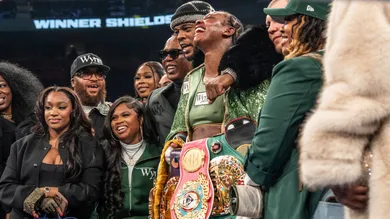 Claressa Shields, center, stands with Papoose and members of her team after defeating Franchon Crews-Dezurn, left, by a
