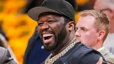 Rapper 50 Cent (left) chats on the sideline Tuesday, May 27, 2025, before Game 4 of the NBA Eastern Conference Finals at