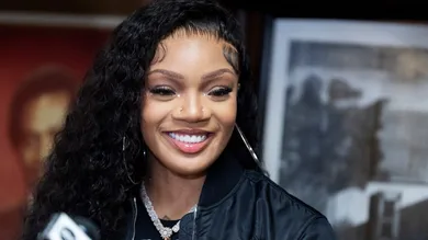Rapper GloRilla smiles during a press conference to present a check for $25,000 to Melrose High School, where she graduated from