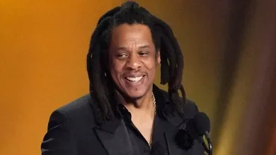 Jay-Z , left, accepts the Dr. Dre Global Impact Award with his daughter Blue Ivy on stage.