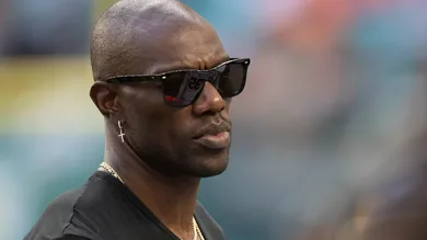 Former NFL wide receiver Terrell Owens stands on the Jackson State University sideline during the Orange Blossom Classic between