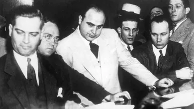 Al Capone (1899 - 1947) signing Uncle Sam's $50,000 bail bond in the Federal Building, Chicago