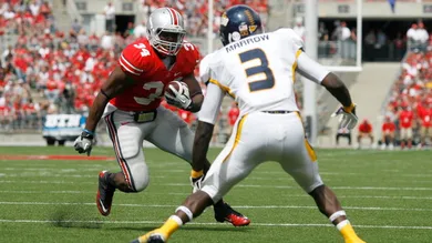 Carlos Hyde #34 of the Ohio State Buckeyes attempts to run past Desmond Marrow #3 of the Toledo Rockets on September 10, 2011 at Ohio Stadium in Columbus, Ohio.