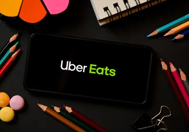 In this photo illustration a Uber Eats logo seen displayed
