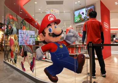 An employee stands next to a Super Mario decoration sticker