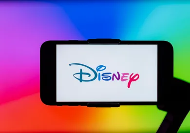 In this photo illustration, Disney logo is seen displayed on