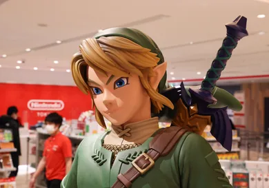 Link figurine from Legend of Zelda with shop staff inside