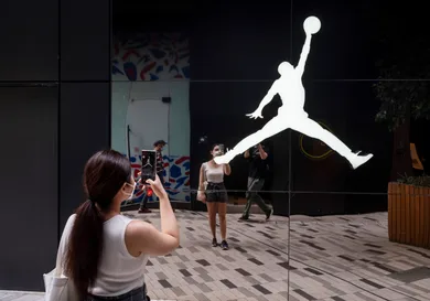 A woman takes a photo of the American sportwear brand,