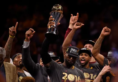With tears in his eyes Cleveland Cavaliers' LeBron James (23) holds up the MVP trophy after defeating the Golden State Warriors in Game 7 of the NBA Finals at Oracle Arena in Oakland, Calif., on Sunday, June 19, 2016. The Cleveland Cavaliers defeated the