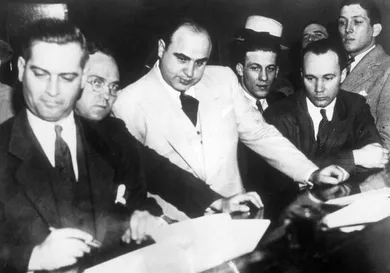 Al Capone (1899 - 1947) signing Uncle Sam's $50,000 bail bond in the Federal Building, Chicago