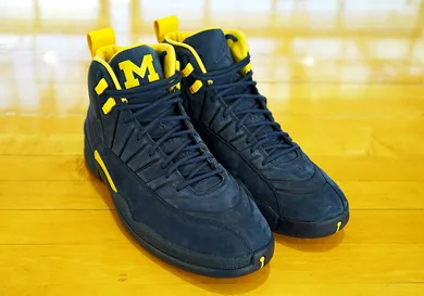 Image Via <a href='https://sneakernews.com/2018/03/20/psny-air-jordan-12-michigan-release-info/' rel="nofollow noopener" target='_blank'>SN</a>