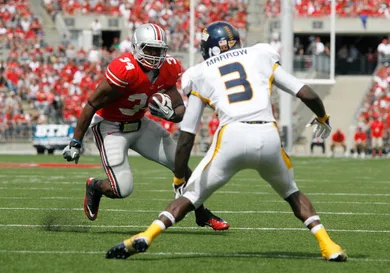 Carlos Hyde #34 of the Ohio State Buckeyes attempts to run past Desmond Marrow #3 of the Toledo Rockets on September 10, 2011 at Ohio Stadium in Columbus, Ohio.