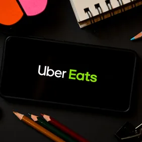 In this photo illustration a Uber Eats logo seen displayed