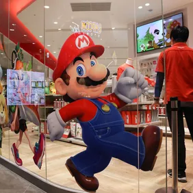 An employee stands next to a Super Mario decoration sticker