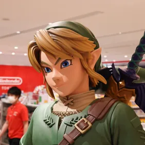 Link figurine from Legend of Zelda with shop staff inside