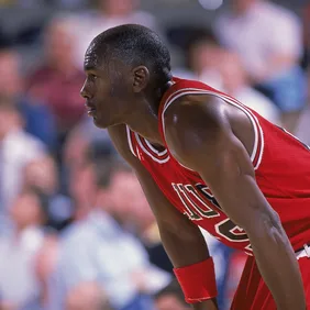 Michael Jordan #23 of the Chicago Bulls rests on the court during a game.
