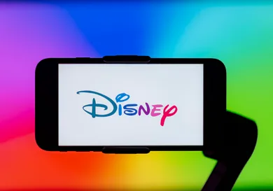 In this photo illustration, Disney logo is seen displayed on