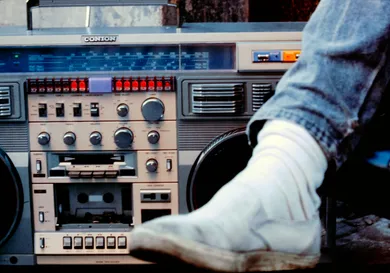 Close up of a male leg next to a large boom box