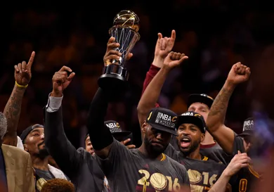 With tears in his eyes Cleveland Cavaliers' LeBron James (23) holds up the MVP trophy after defeating the Golden State Warriors in Game 7 of the NBA Finals at Oracle Arena in Oakland, Calif., on Sunday, June 19, 2016. The Cleveland Cavaliers defeated the