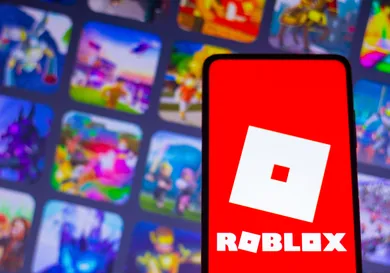 In this photo illustration, the Roblox logo seen displayed