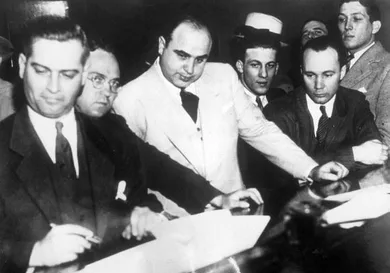 Al Capone (1899 - 1947) signing Uncle Sam's $50,000 bail bond in the Federal Building, Chicago